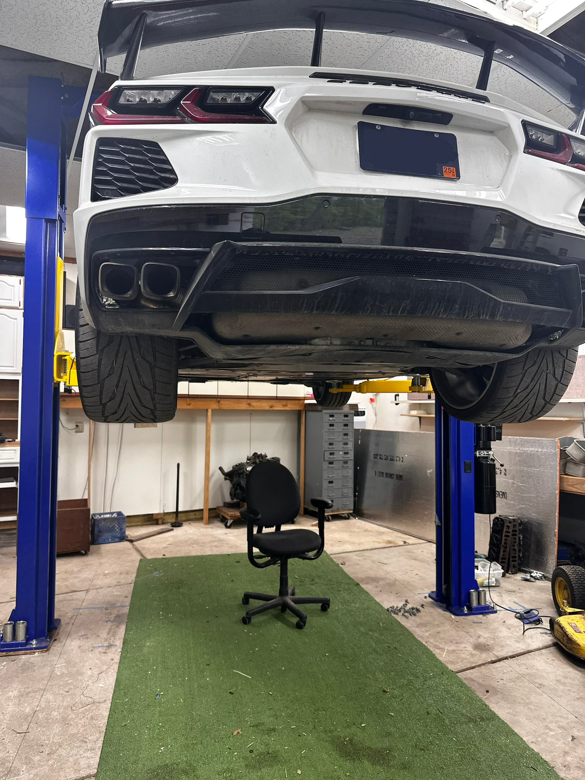 Corvette raised on a lift during vehicle work